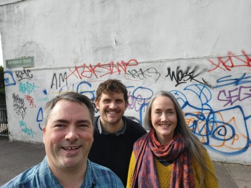Dave McElroy, Jamie Whitham and Kat McCann in front of graffiti